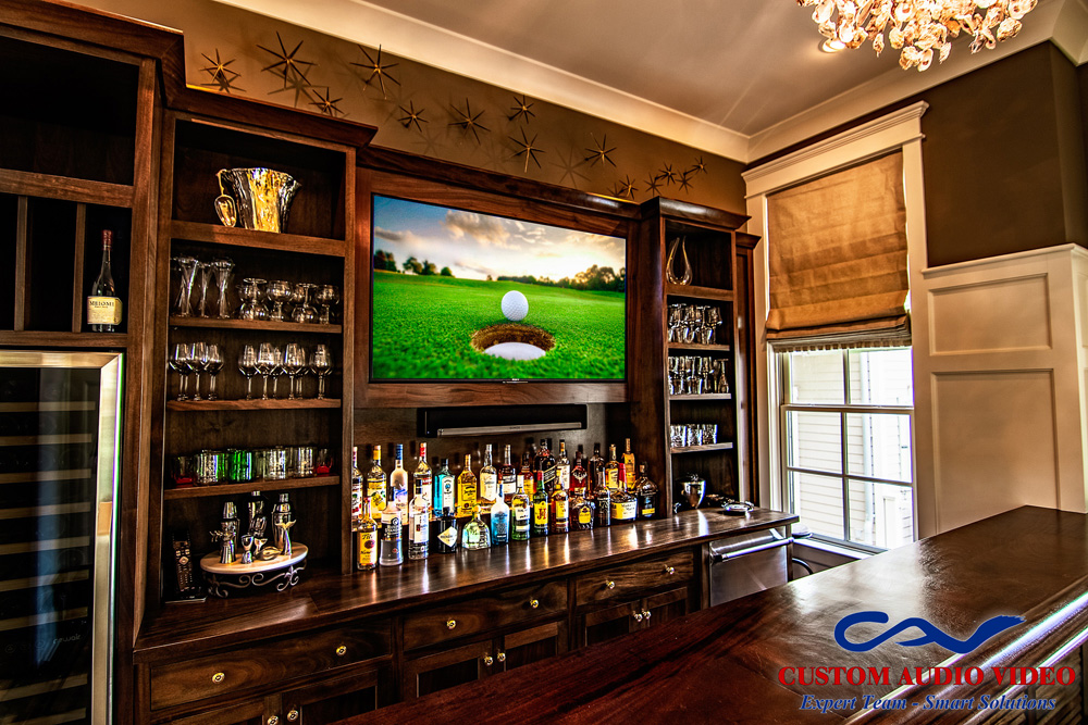 A luxury home in Palmetto Bluff includes a sports bar with installed Sony television and Sonos soundbar.